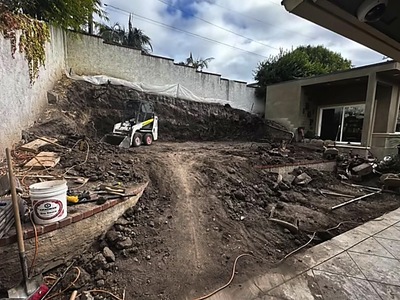 Skid steer at work during backyard pool excavation in La Verne, CA