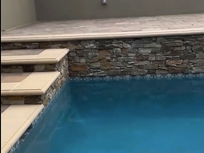 Stacked stone veneer and coping at the pool corner in La Verne, CA