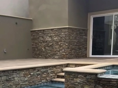 Stacked stone wall base beside the sliding door of a La Verne home