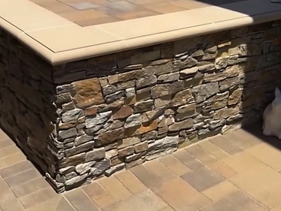 Stacked stone detail on the raised spa wall with stone cap in La Verne, CA