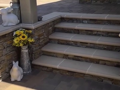 Paver steps with stacked stone risers and garden decor beside the pool in La Verne
